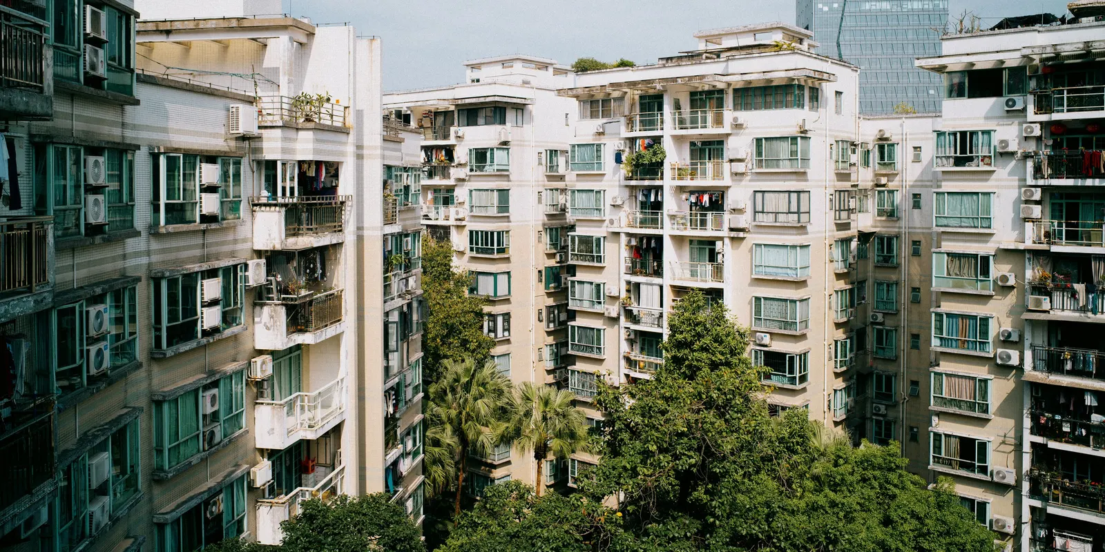 Dense residential blocks towering against an overcast sky.