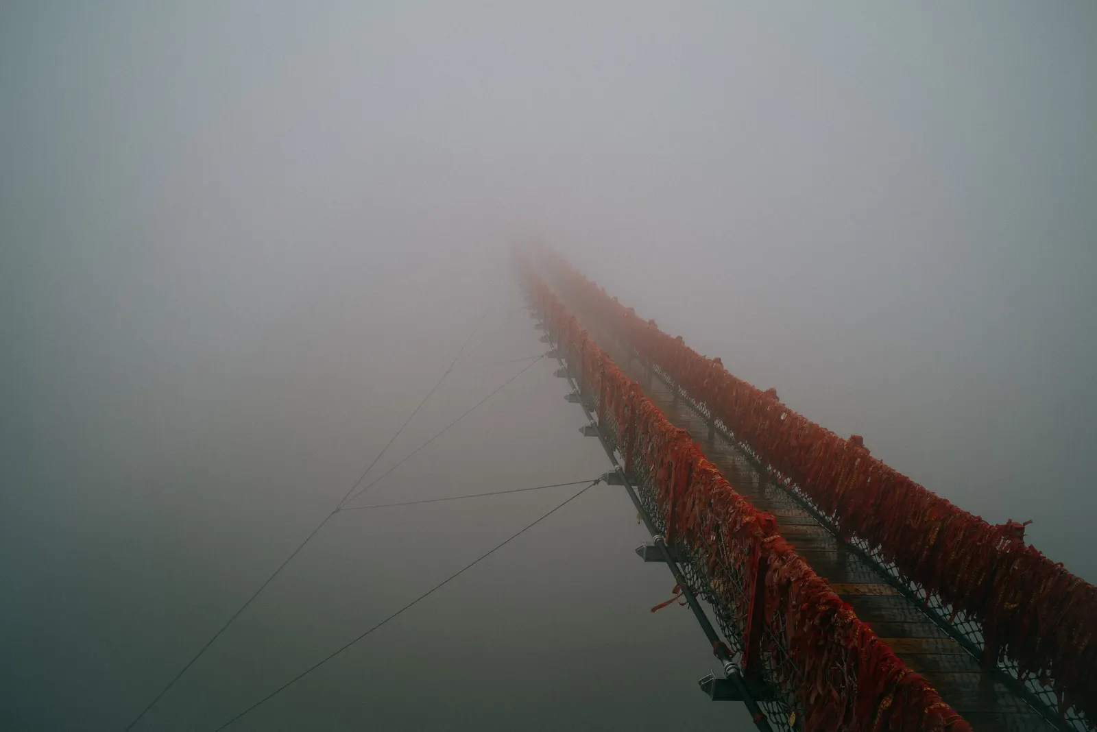 A fishing boat lost in fog on the water.
