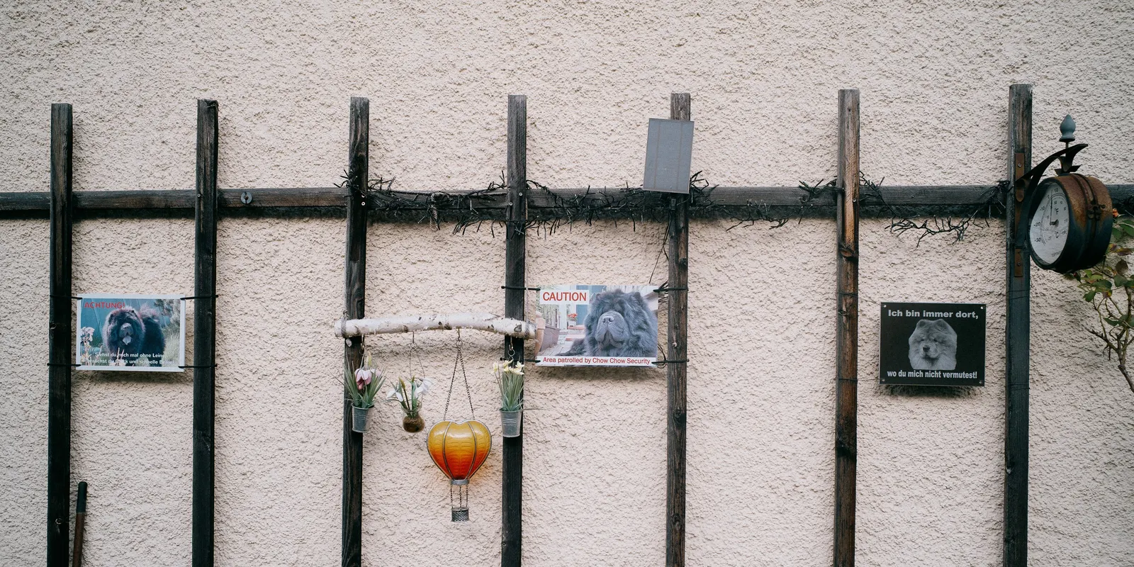 Framed pictures hung on the railings, and a glass left behind.