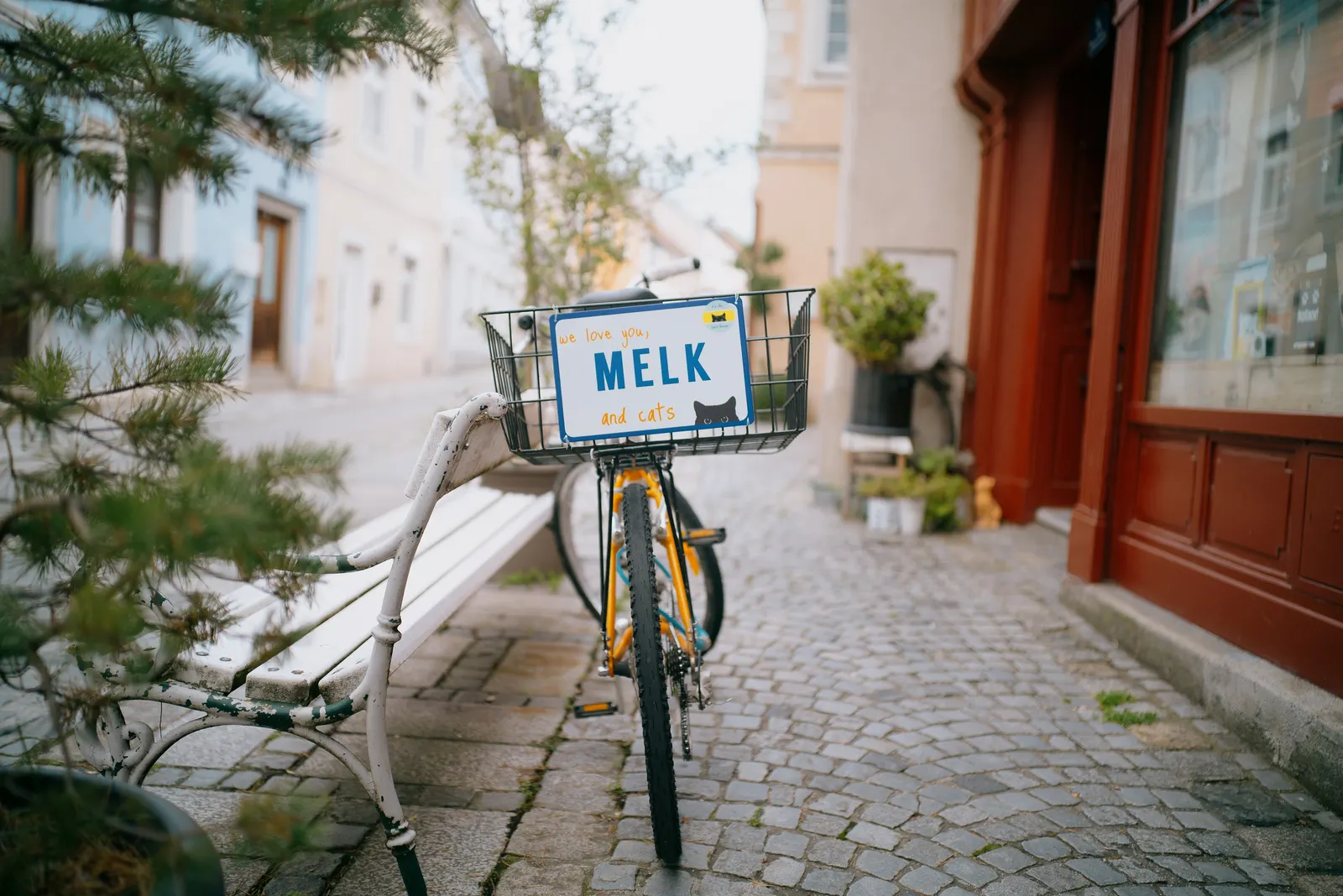 Arrival in Melk — the sign, the red corner, a parked bicycle.