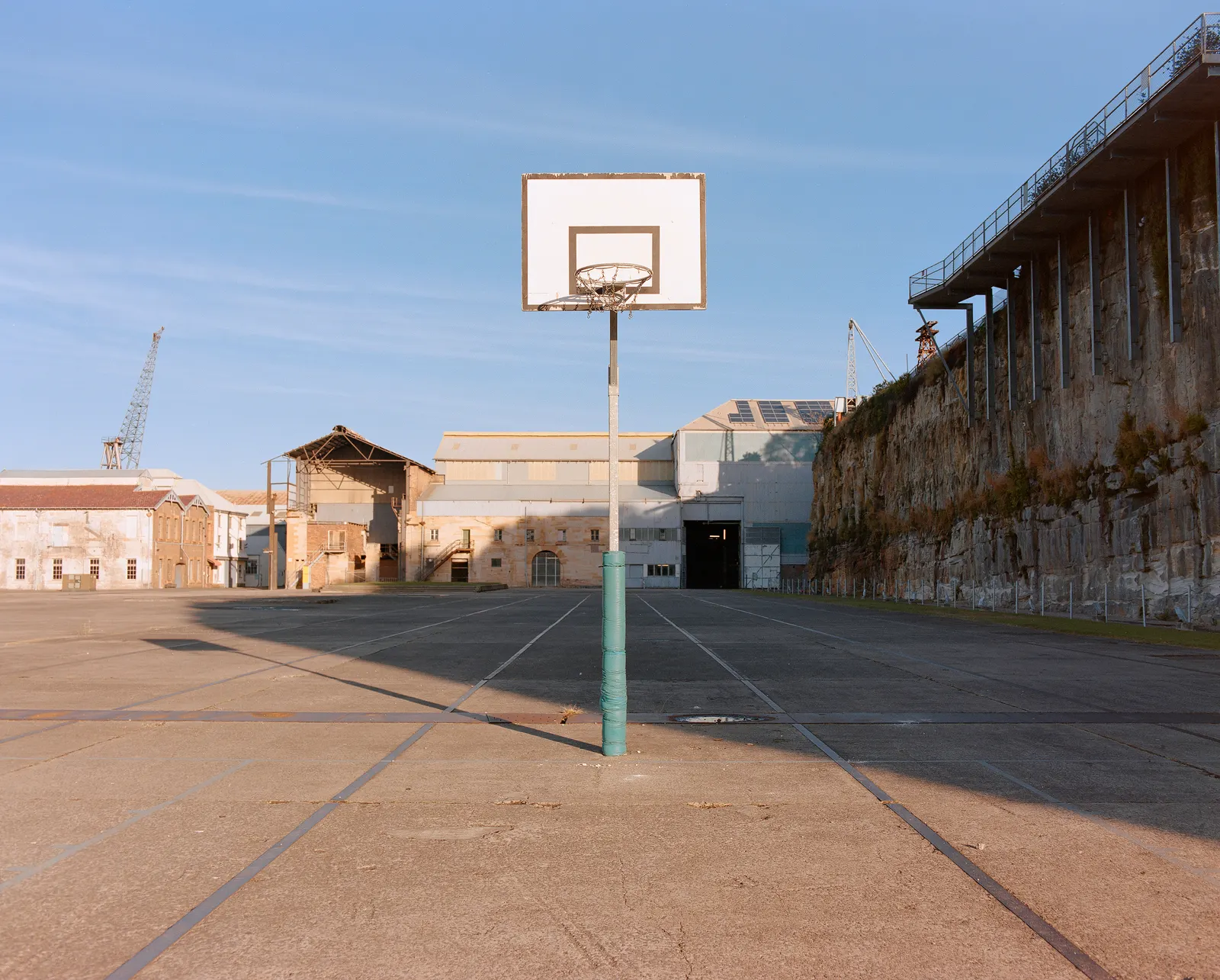 An empty court in an industrial lot.