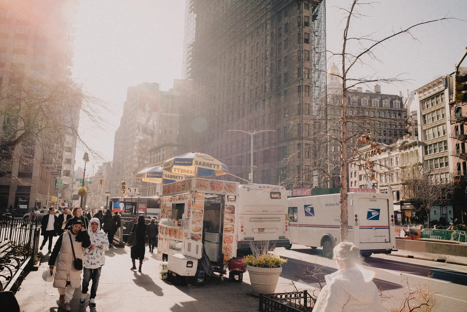 A street under low cloud, the towers half-gone.