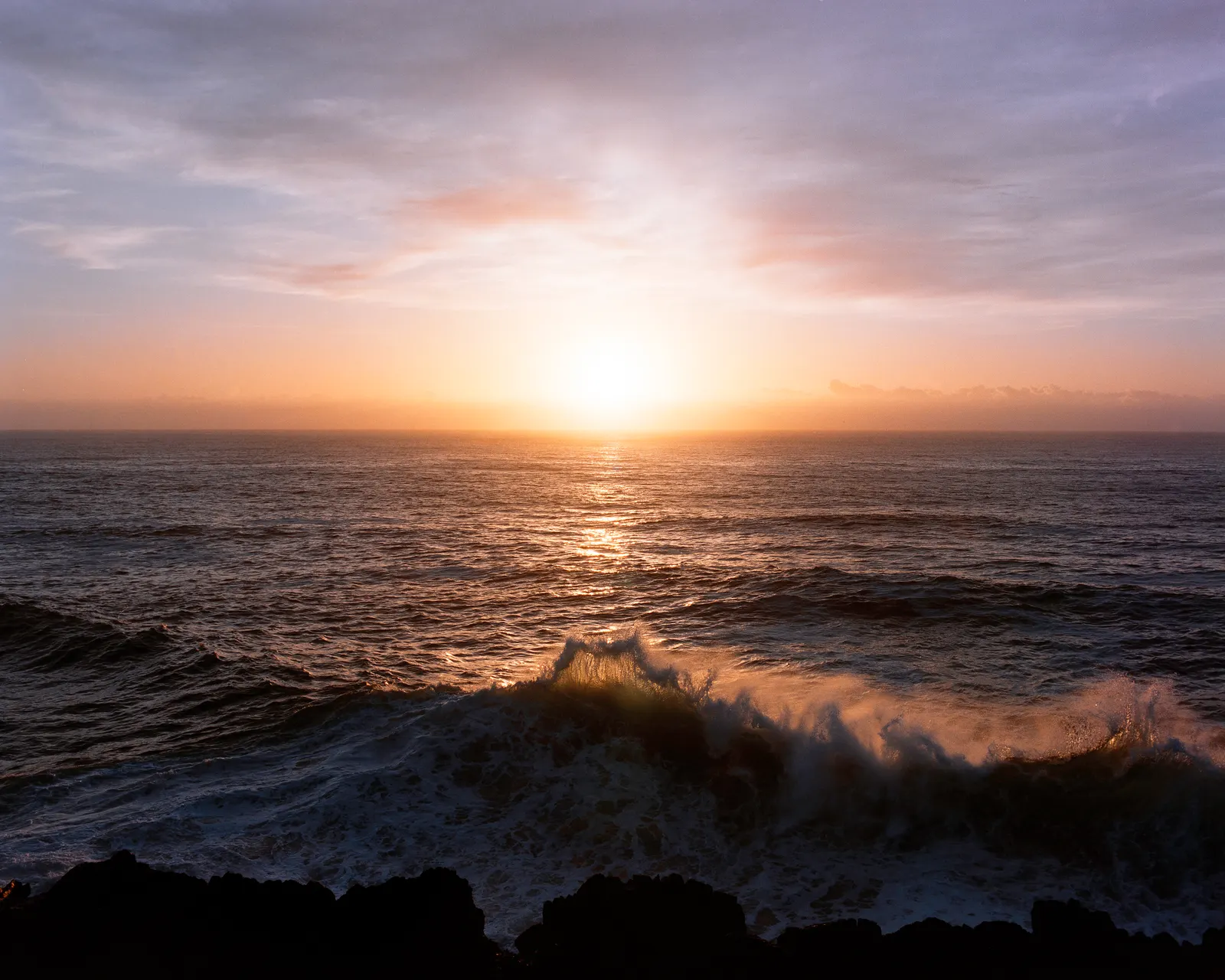 Waves breaking against the headland.